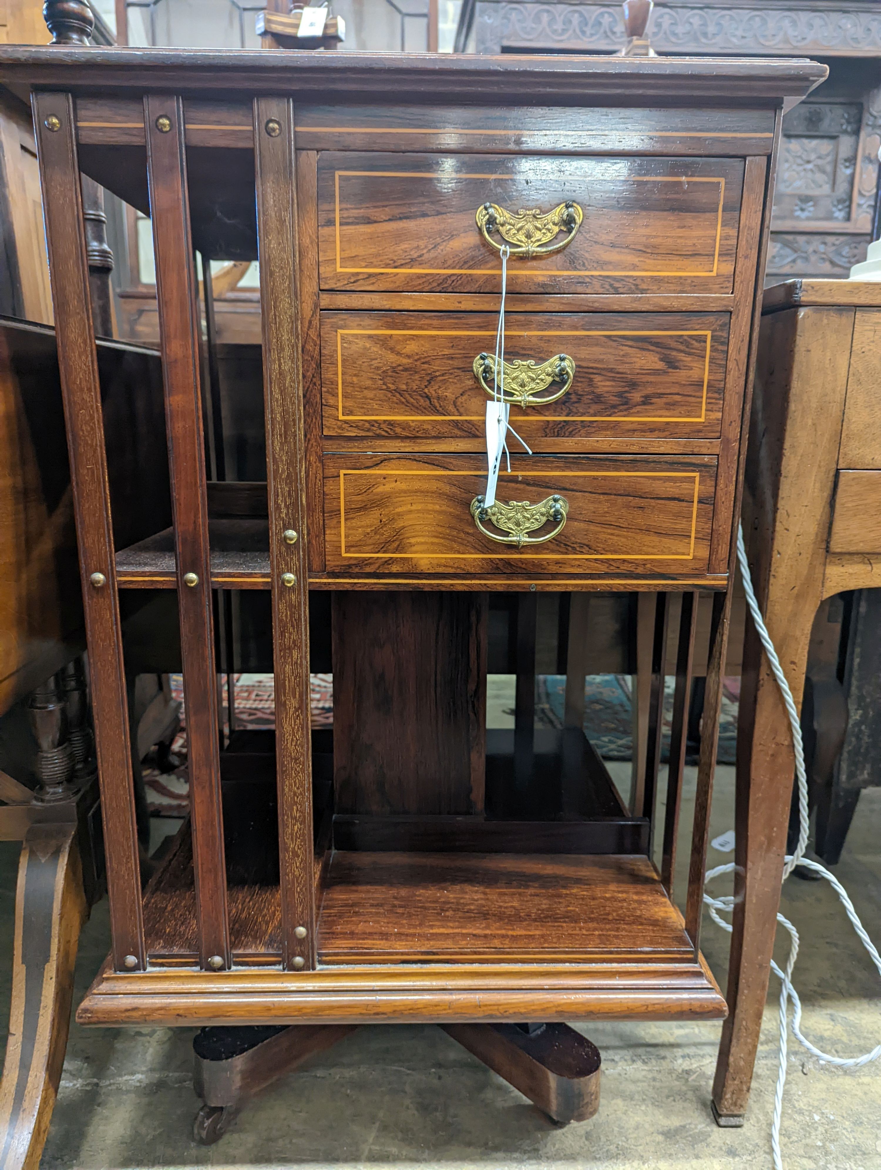An Edwardian inlaid rosewood revolving bookcase fitted three drawers, width 52cm, depth 51cm, height 88cm